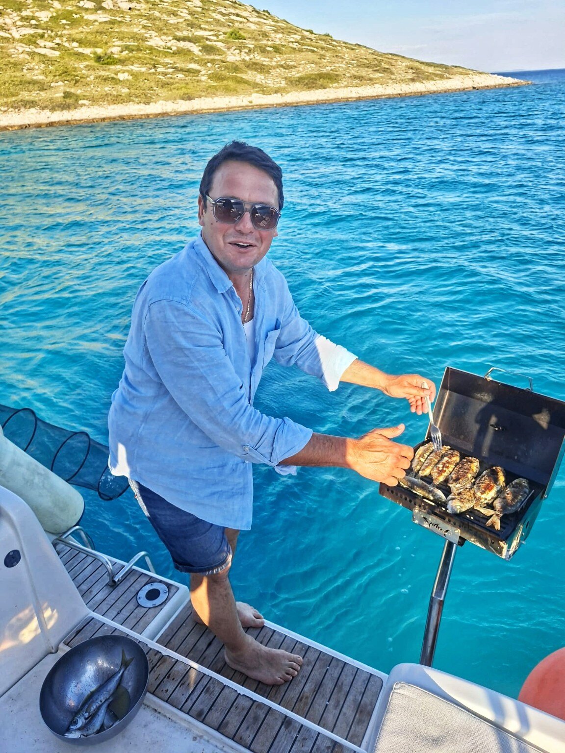 Skipper grilling fresh fish aboard