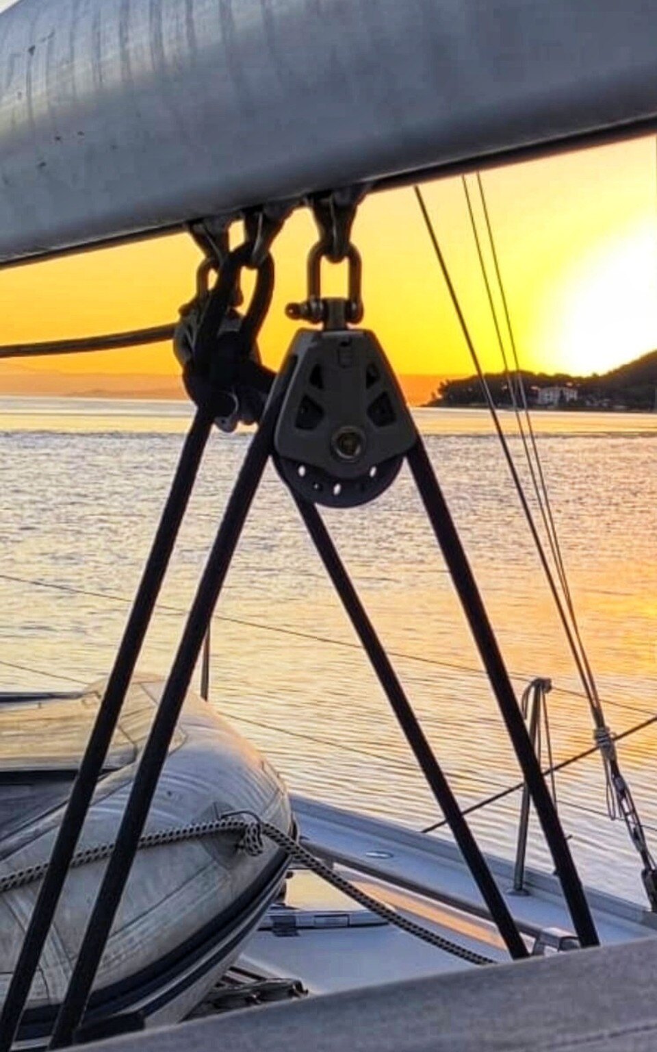 Golden sunset through the yacht rigging