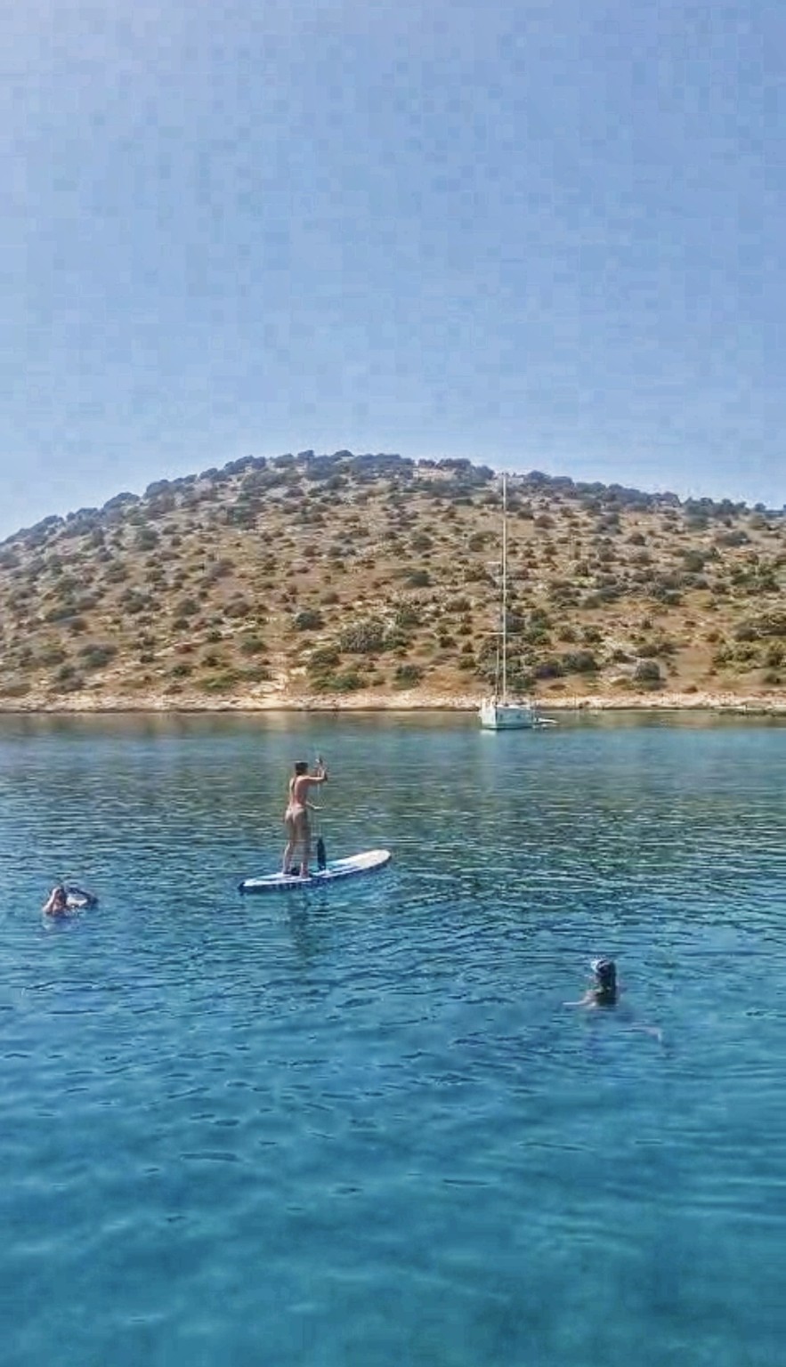 Paddleboarding and swimming in a sheltered Croatian bay