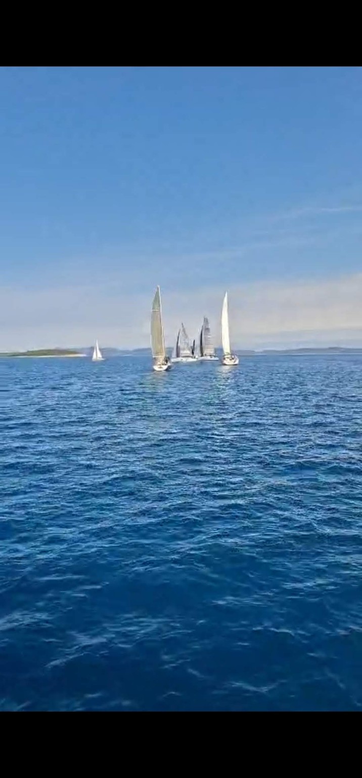 Sailing boats together on the blue Adriatic near Murter