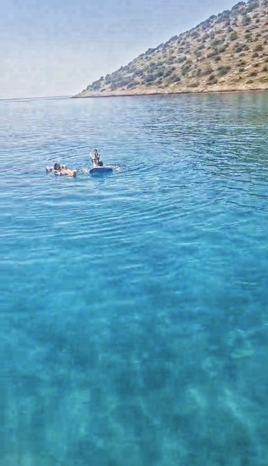 Guests swimming in clear turquoise Adriatic water